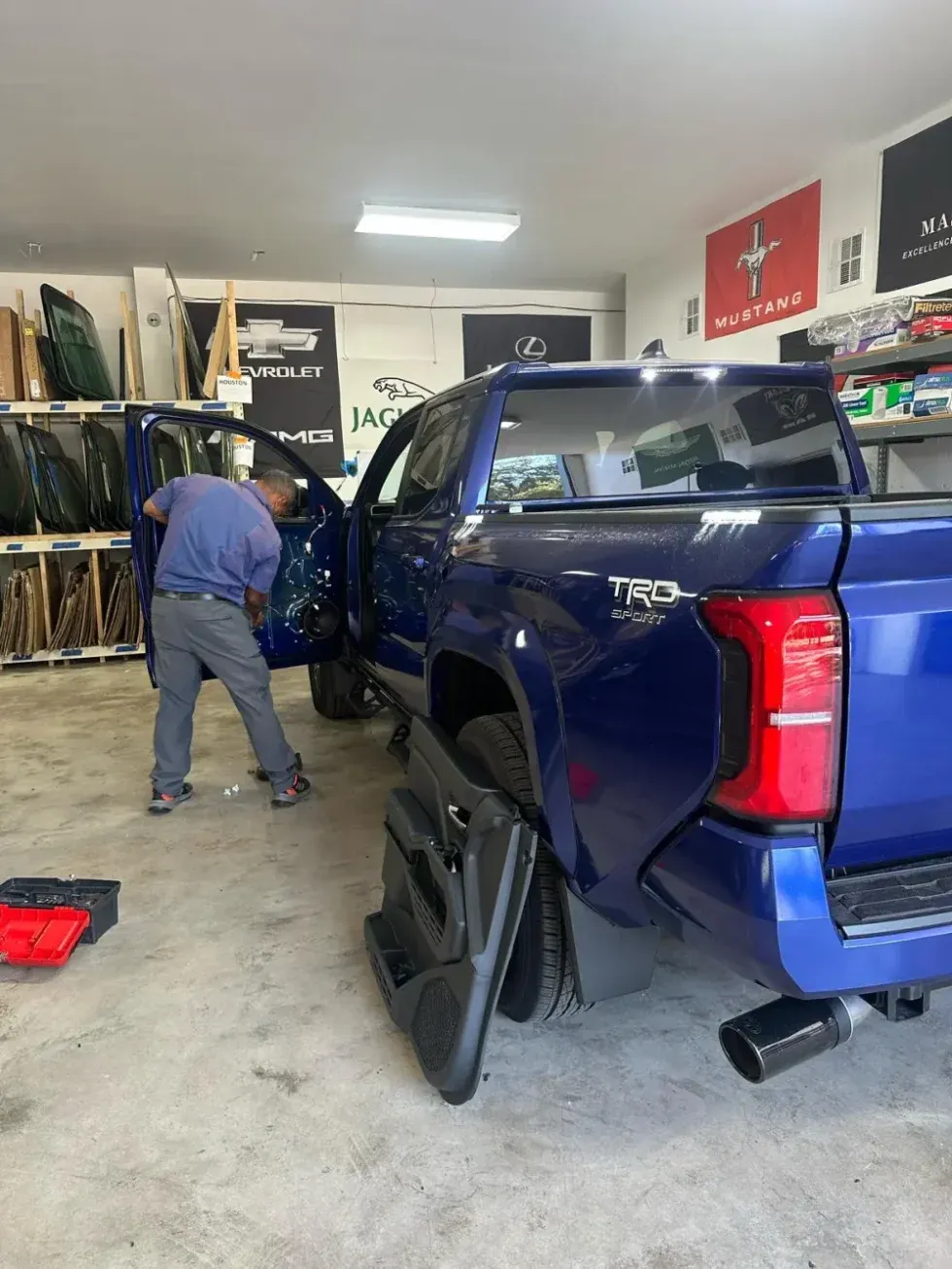 Windshield replacement in progress at customer location